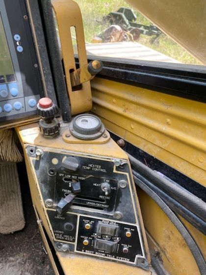 A close up of a control panel on a yellow vehicle