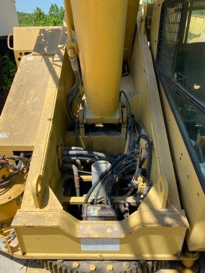 The inside of a yellow crane with a lot of wires coming out of it.