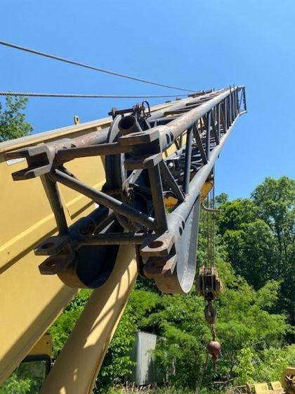A large yellow crane with a blue sky in the background