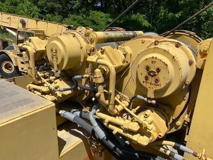 A close up of a yellow machine with a lot of tubes coming out of it.