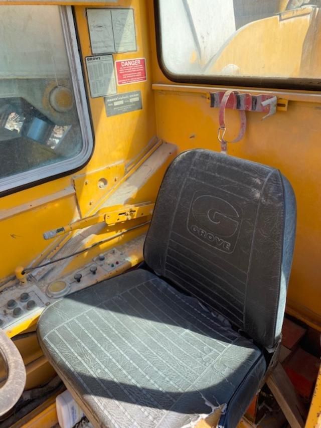 A yellow vehicle with a black seat and a window.