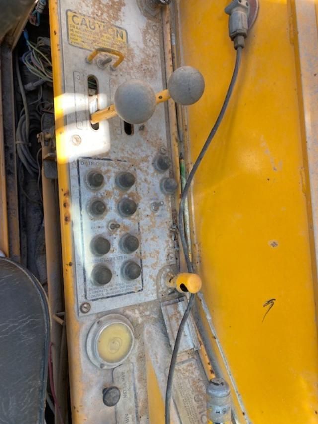 A close up of a control panel on a yellow vehicle.