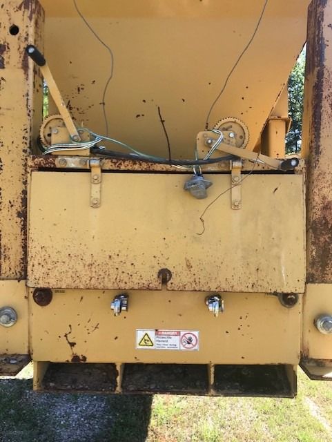 A yellow machine with a warning sign on it