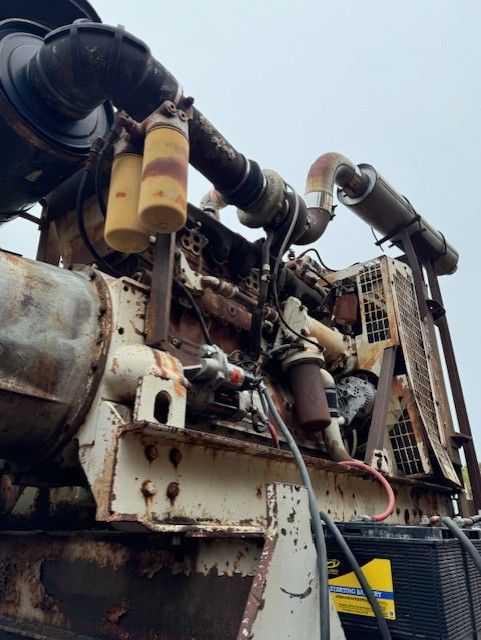 An old rusty engine with a yellow filter on it