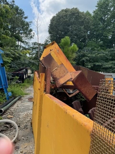 A pile of rusty metal is sitting in a yellow bin