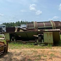 A large machine is sitting in the middle of a field.