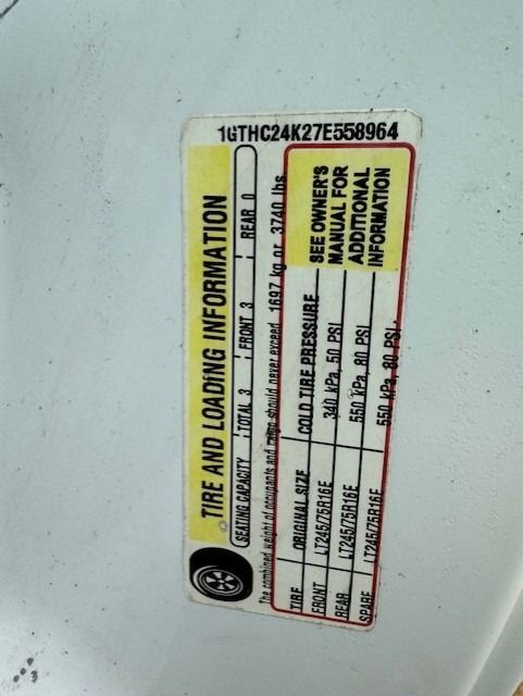 A tire and loading information label on a white vehicle