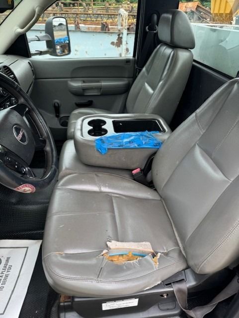 The inside of a truck with a damaged seat