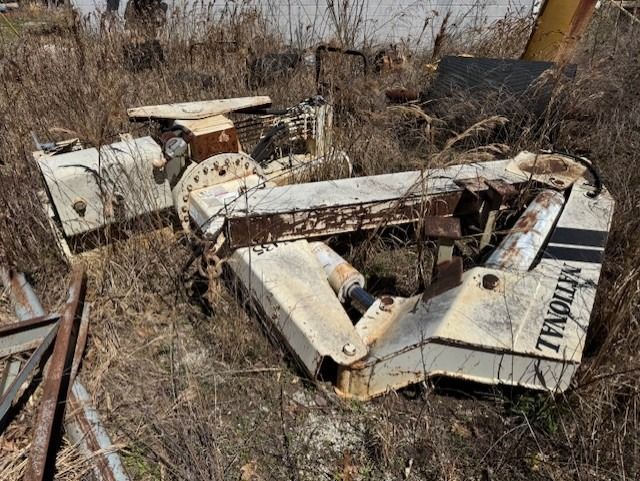 A large piece of metal is sitting in the middle of a field.