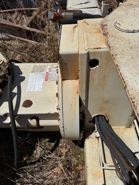 A white machine with a warning label on it