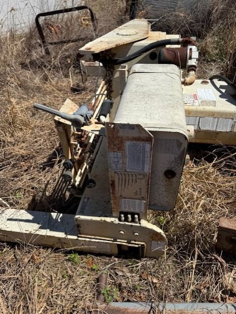 A tractor is sitting in the middle of a field.