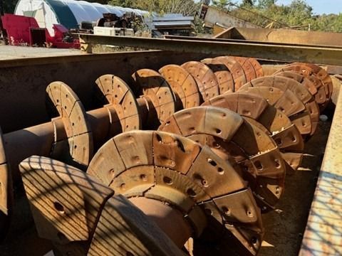 A bunch of spools of metal are sitting on top of each other
