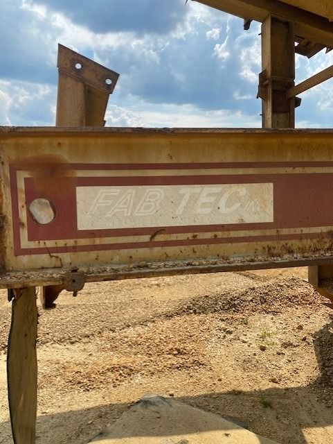 A sign that says pacific on it is in the middle of a dirt field.