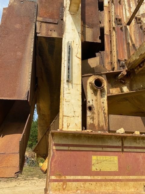 A rusty metal structure with a yellow sticker that says ' a ' on it