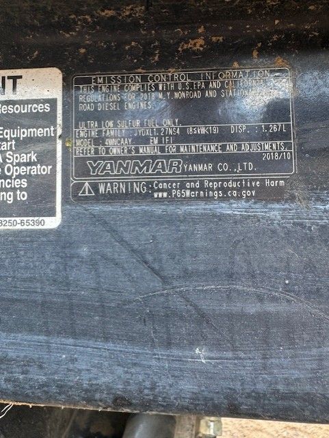 A yanmar engine with a warning label on it