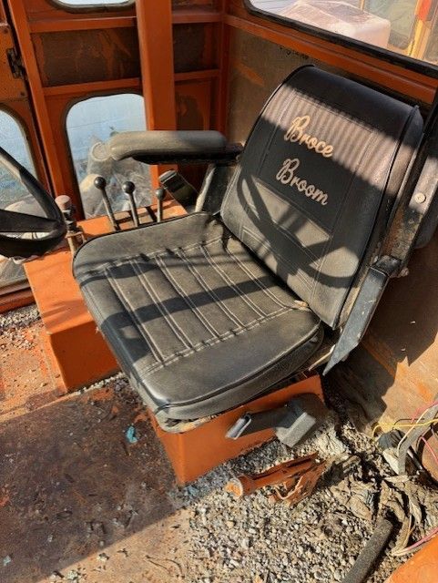 A chair with the word broom embroidered on it