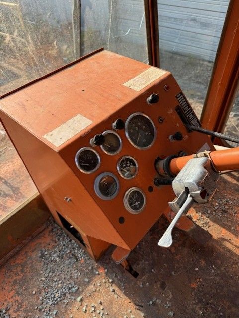 An orange box with a lot of buttons and gauges on it