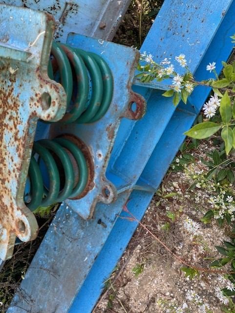 A close up of a blue item with green springs on it