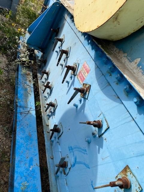 A close up of a blue item with screws on it