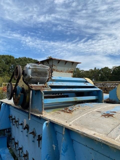 A blue machine with a motor on top of it