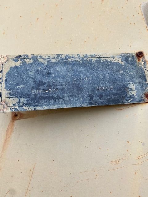 A blue and white sign is sitting on a white surface.