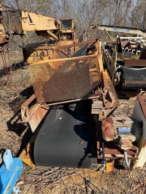 A pile of rusty machinery is sitting in the dirt