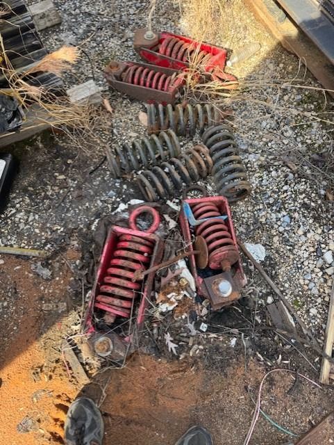 A bunch of springs are laying on the ground.