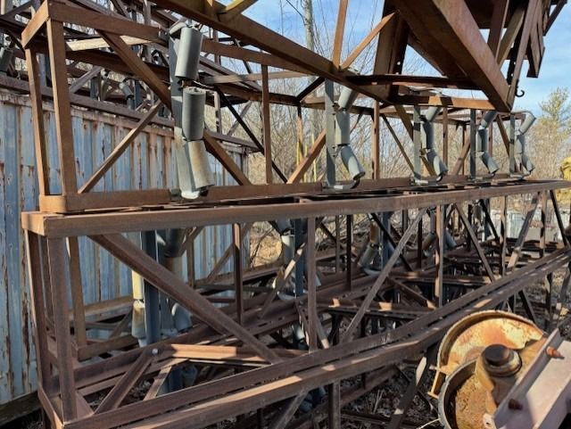A bunch of rusty metal structures are stacked on top of each other