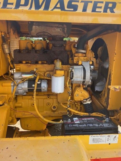 A yellow tractor with the word master on it