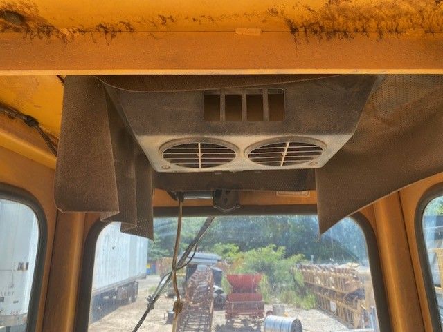 A fan is hanging from the ceiling of a vehicle.