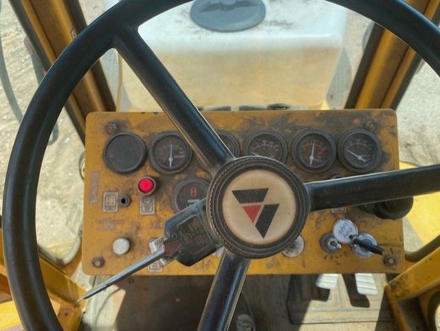 A steering wheel with a triangle logo on it