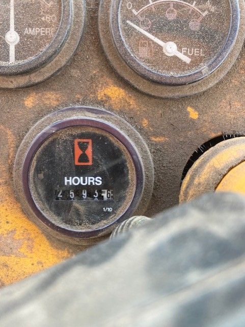 A close up of a gauge that says hours on it