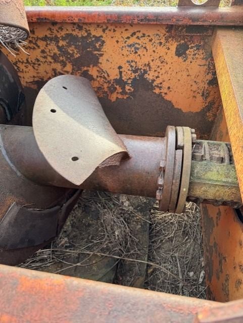 A close up of a rusty pipe on a rusty machine.