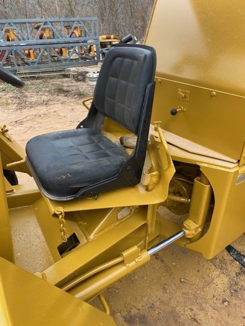 A yellow vehicle with a black seat on it