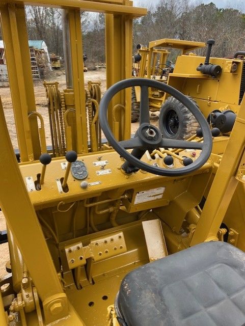 A yellow forklift with a black seat and steering wheel