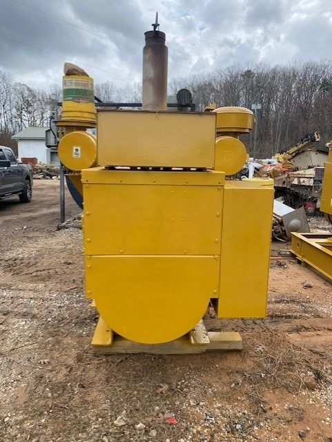 A yellow machine with a smoke stack on top of it