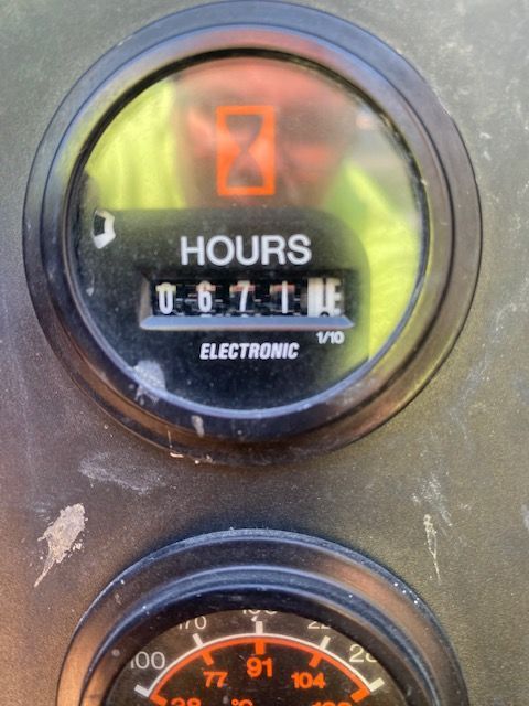 A close up of a gauge that says hours on it