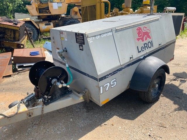 A leroy air compressor is sitting on a trailer.