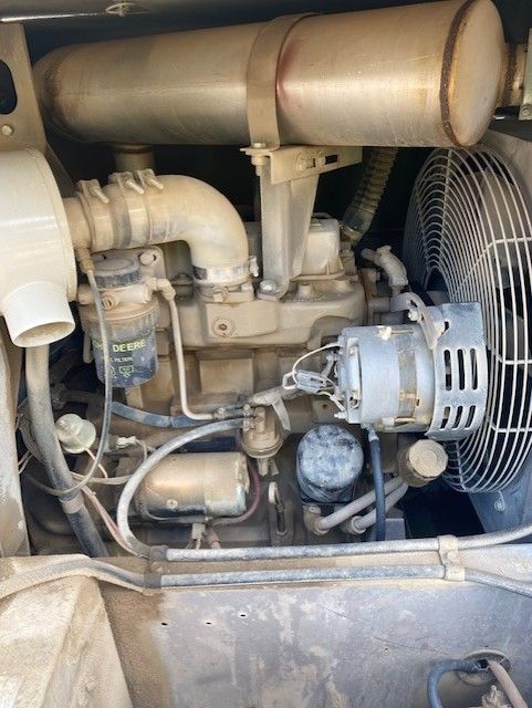 A close up of the engine of a machine with a fan.