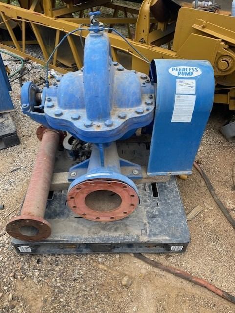 A blue pump is sitting on a pallet on the ground