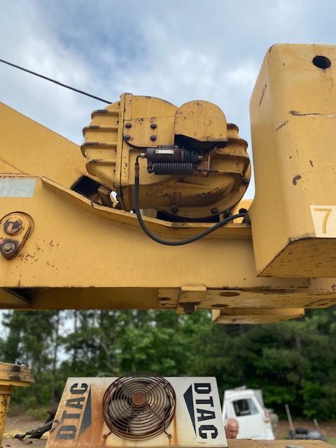 A yellow tractor with the word dtac on it