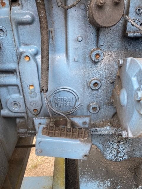 A close up of a blue engine on a wooden table.
