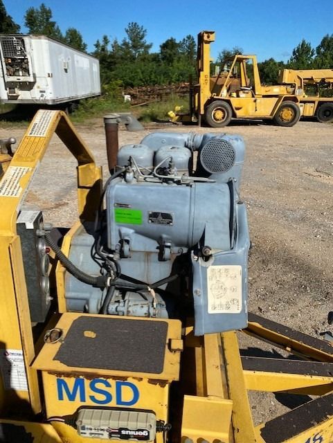 A yellow msd machine sits in a parking lot