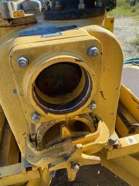 A close up of a yellow machine with a hole in it