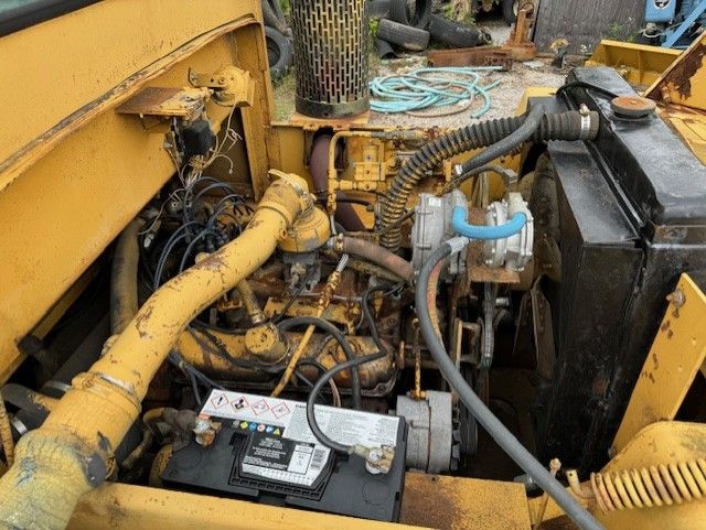 A close up of the engine of a yellow vehicle
