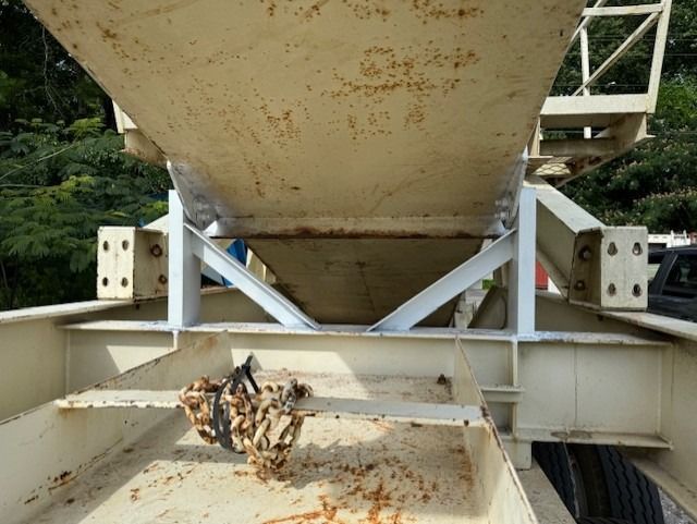 The bottom of a large metal container with a ladder attached to it