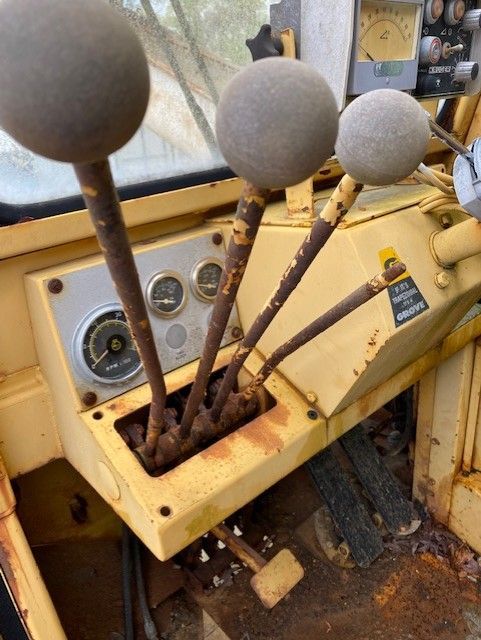 A close up of a steering wheel on a yellow vehicle