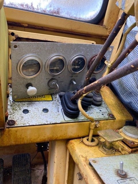 A close up of a control panel on a yellow vehicle