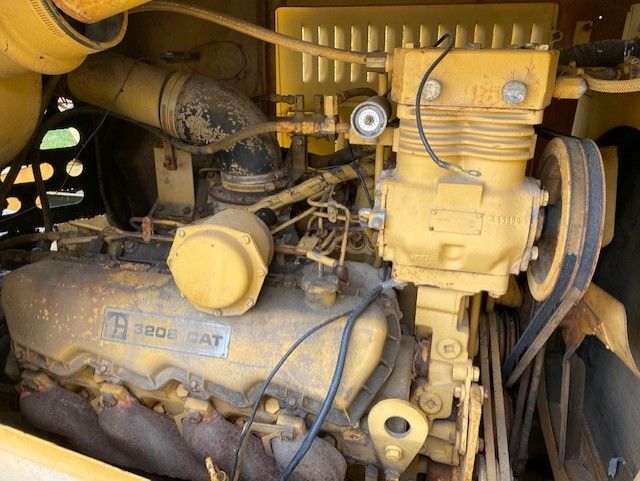 A close up of a cat engine with a lot of wires coming out of it