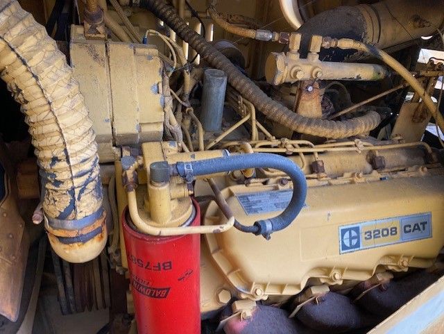 A close up of a cat engine with a red filter attached to it.